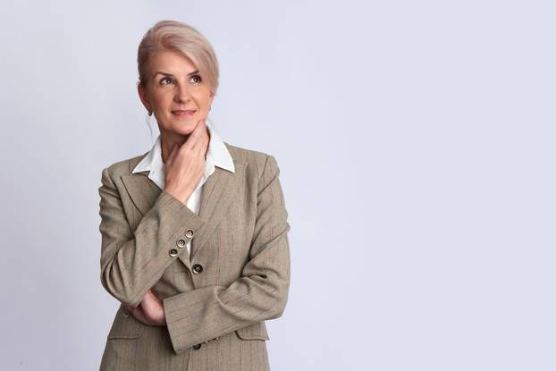 old businesswoman looking up to copy space. Isolated