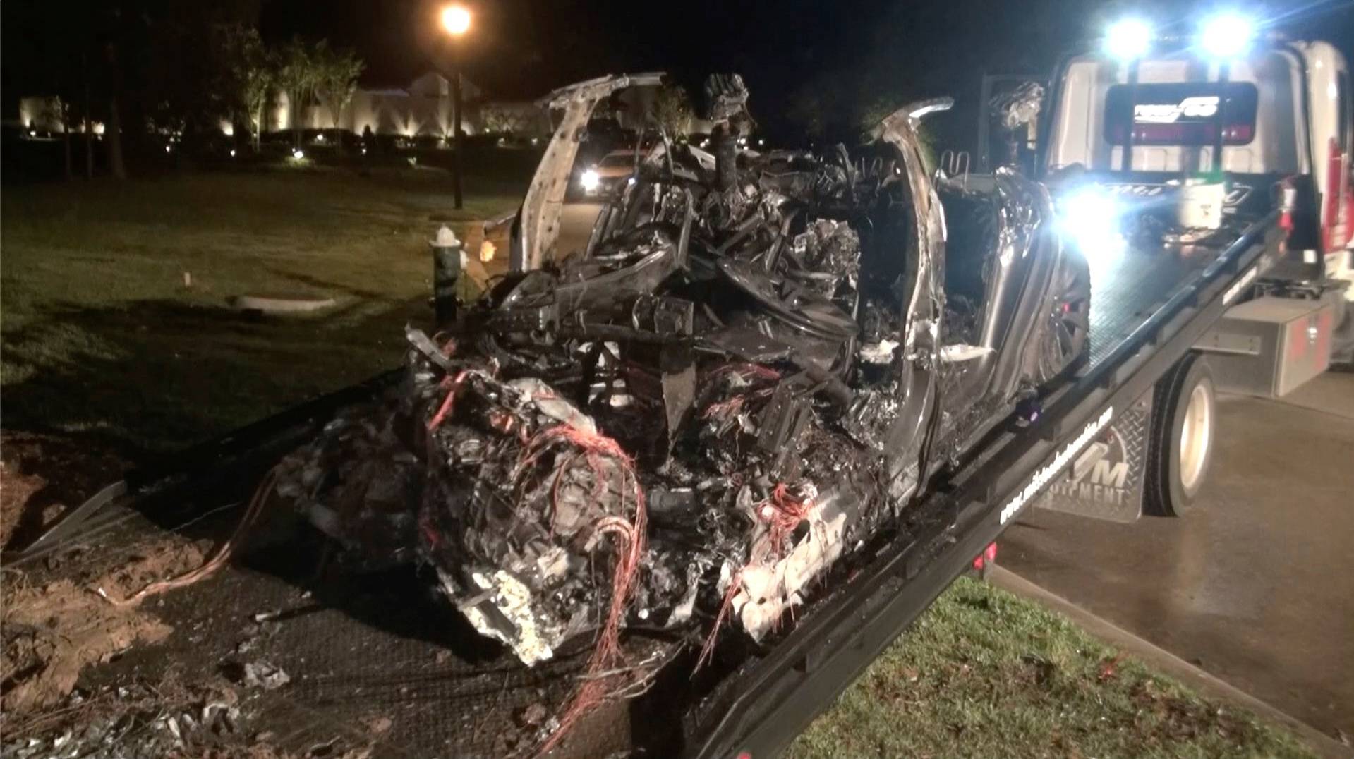 The remains of a Tesla vehicle are seen after it crashed in The Woodlands, Texas