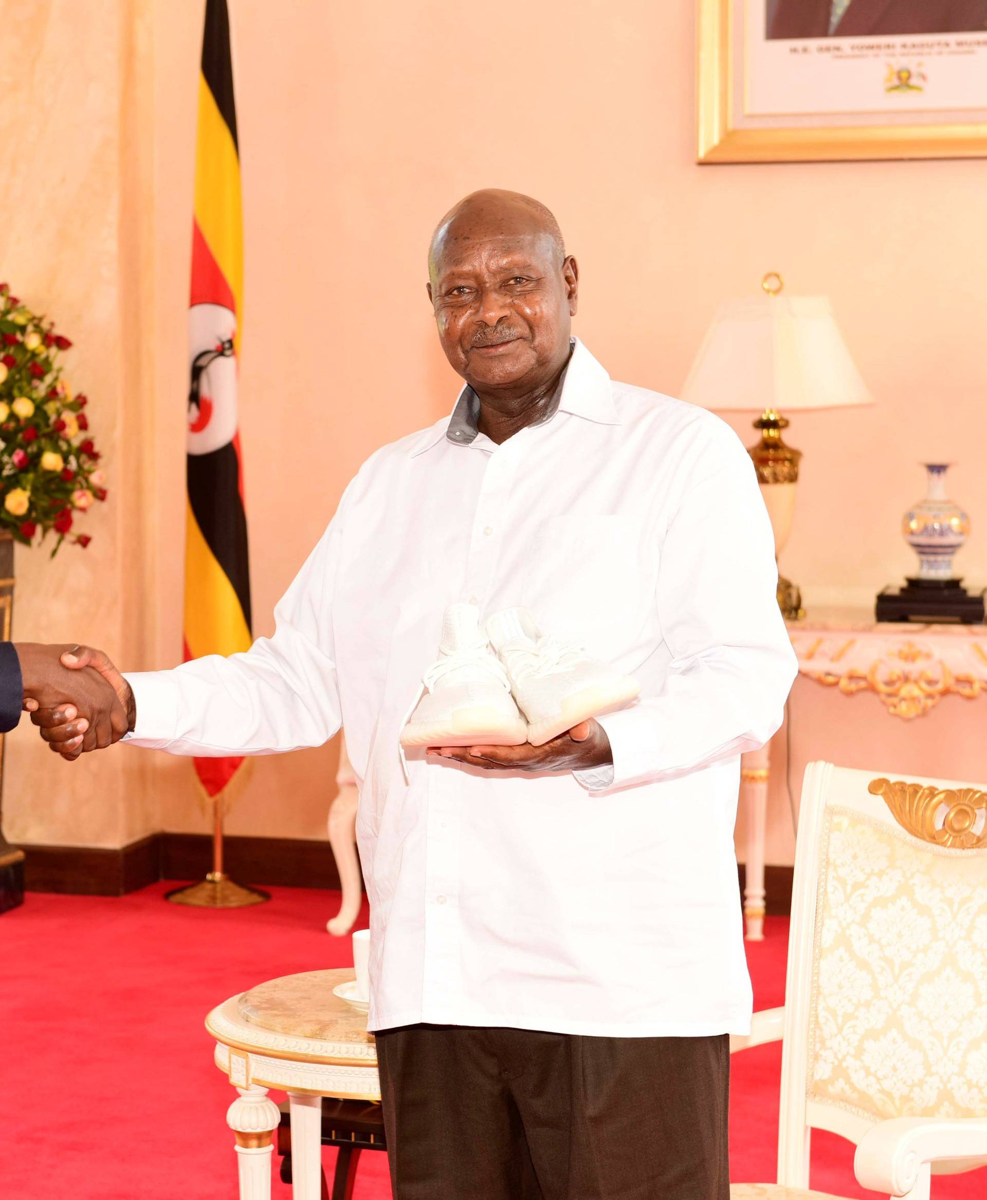Rapper Kanye West (L) meets Uganda's President Yoweri Museveni when he paid a courtesy call at State House