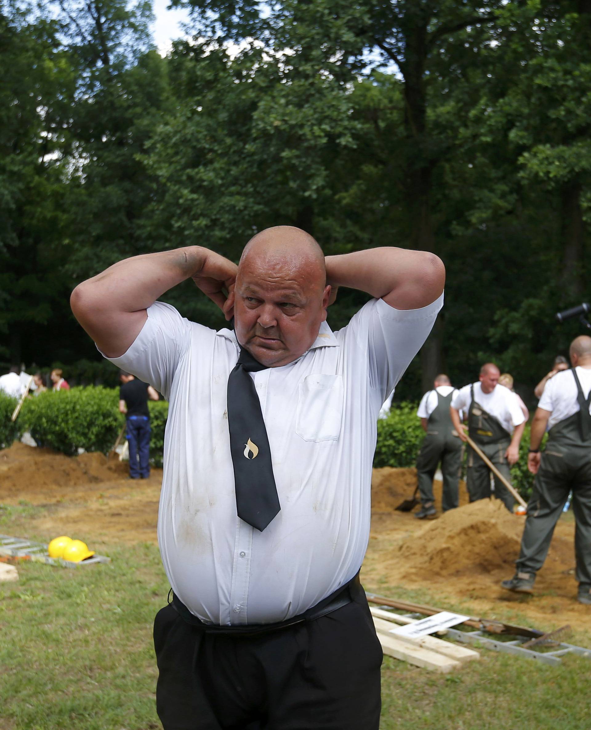 Gravediggers change into formal clothes after Hungarian grave digging championship in Debrecen