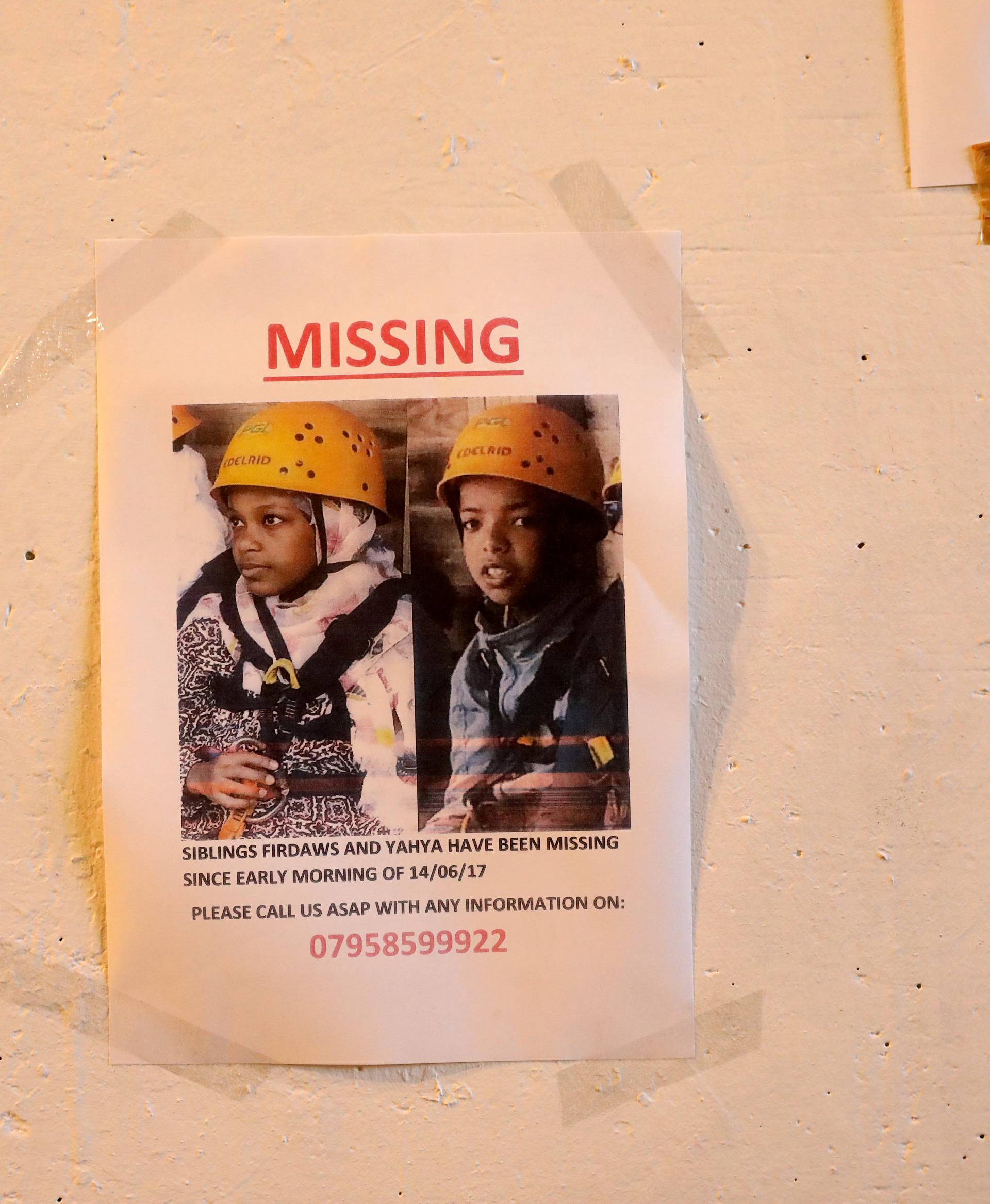 A missing person sign is seen near the scene of the fire which destroyed the Grenfell Tower block,west London