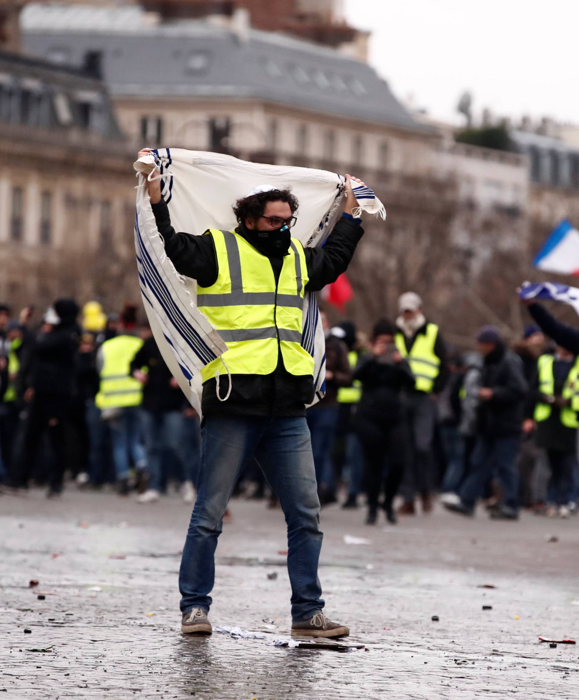 Protesters wearing yellow vests take part in a demonstration by the "yellow vests" movement near the Arc de Triomphe in Paris