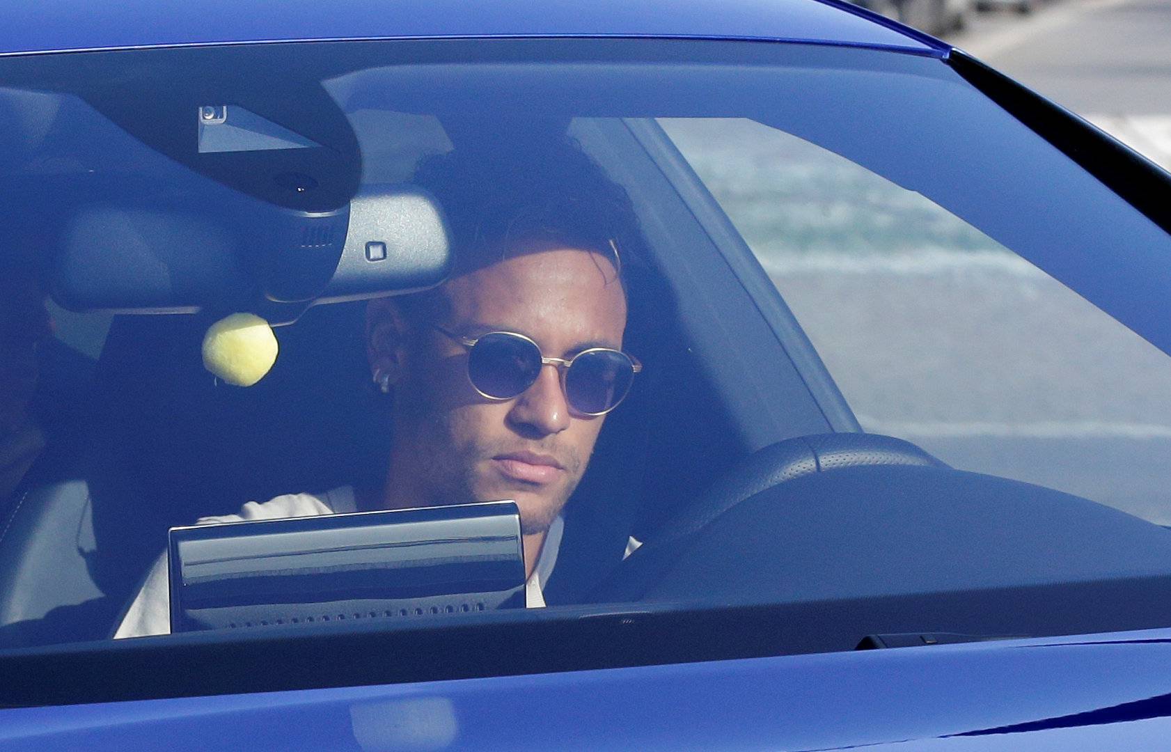 Brazilian soccer player Neymar drives to arrive to Joan Gamper training camp near Barcelona