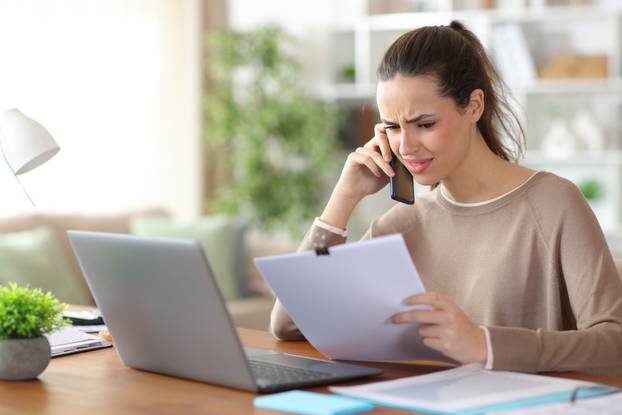 Confused,Self,Employed,Talking,On,Phone,About,Report,Working,At