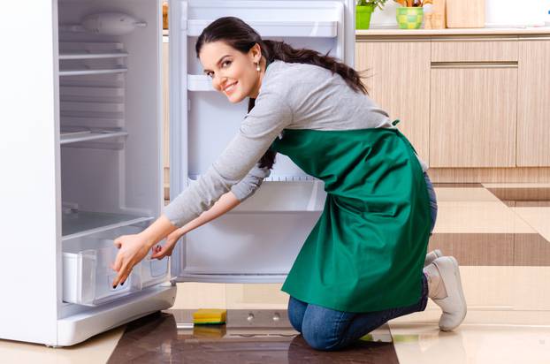 Young,Woman,Cleaning,Fridge,In,Hygiene,Concept