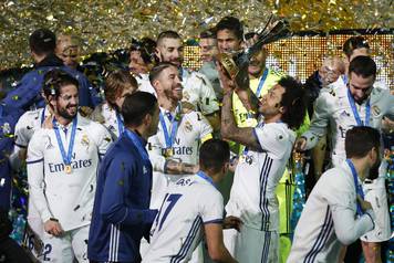 Real Madrid's Marcelo and team mates celebrate winning the FIFA Club World Cup Final with the trophy
