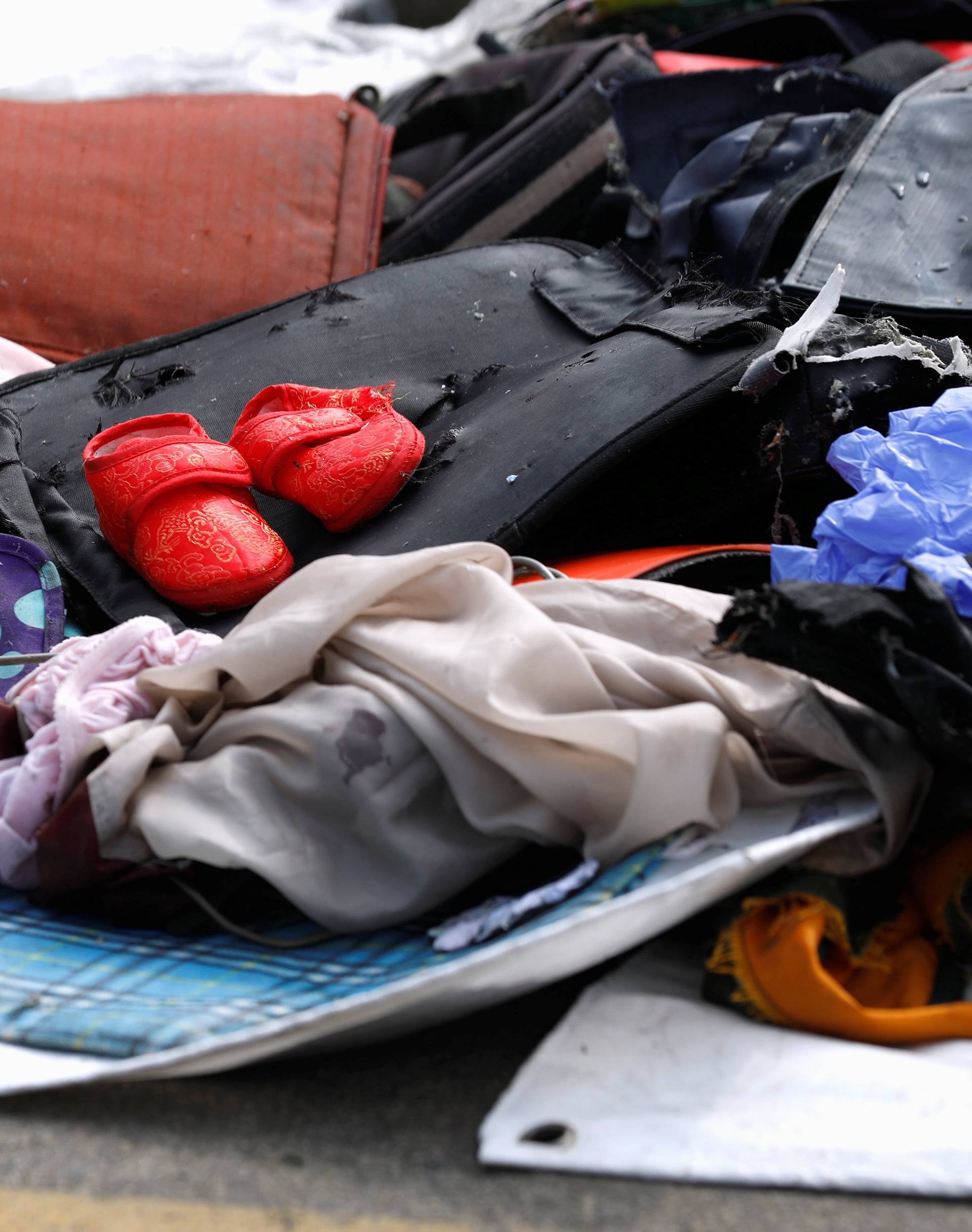 A pair of infant shoes is pictured among recovered belongings believed to be from the crashed Lion Air flight JT610 at Tanjung Priok port in Jakarta