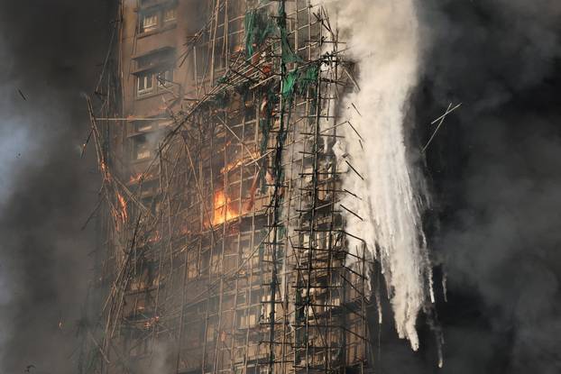 Flames engulf bamboo scaffolding across multiple buildings at Wang Fuk Court housing estate, in Tai Po