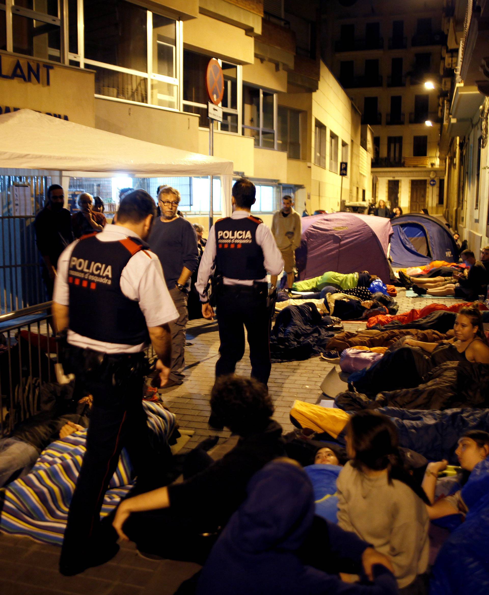 Catalan Mossos d'Esquadra officers arrive while parents camp out at the entrance of the occupied Reina Violant elementary school since the night before the October 1 independence referendum in Barcelona