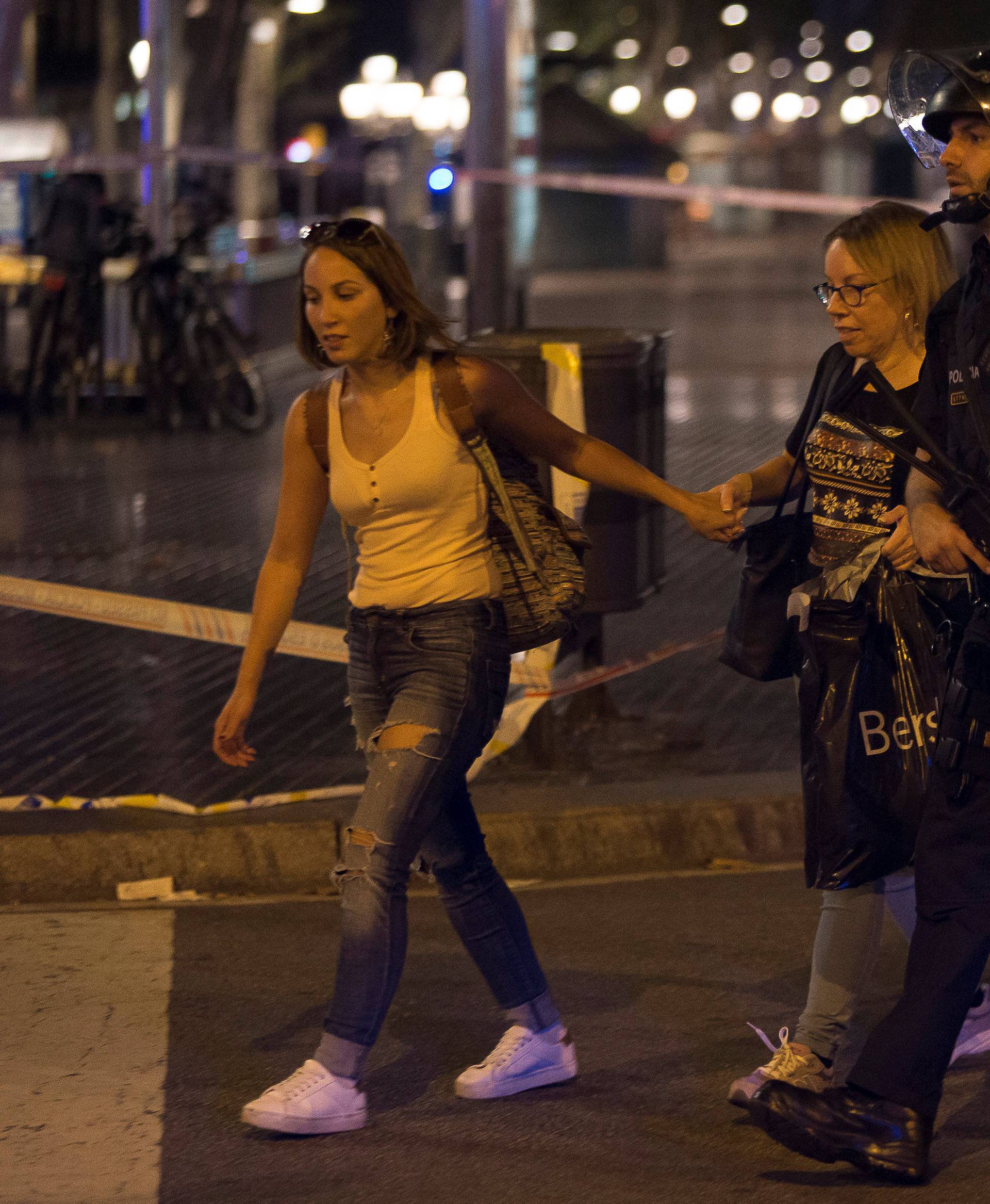 Police evacuate people after a van crashed into pedestrians near the Las Ramblas avenue in central Barcelona