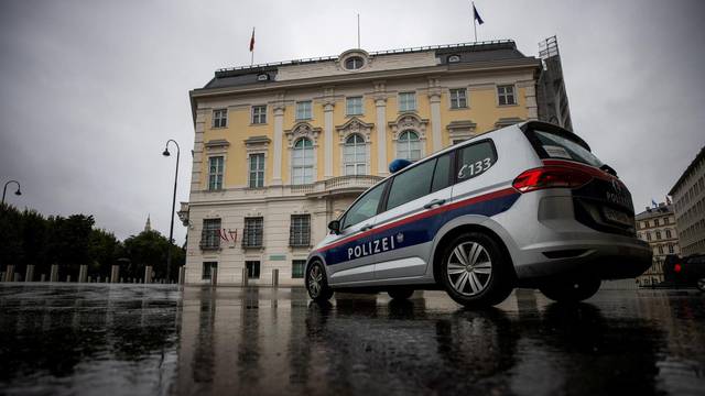 FILE PHOTO: Police car parks in front of the Austrian federal chancellery, in Vienna