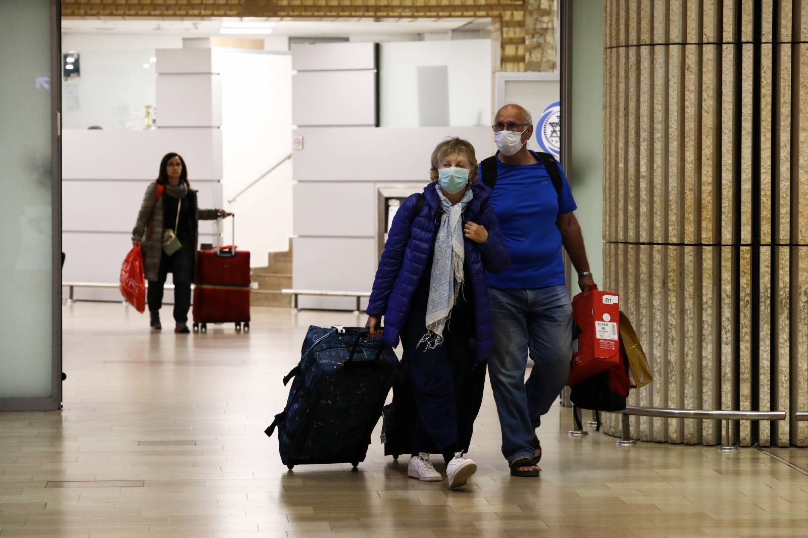 Passengers walk at the arrival area of a terminal at the Ben Gurion airport in Lod