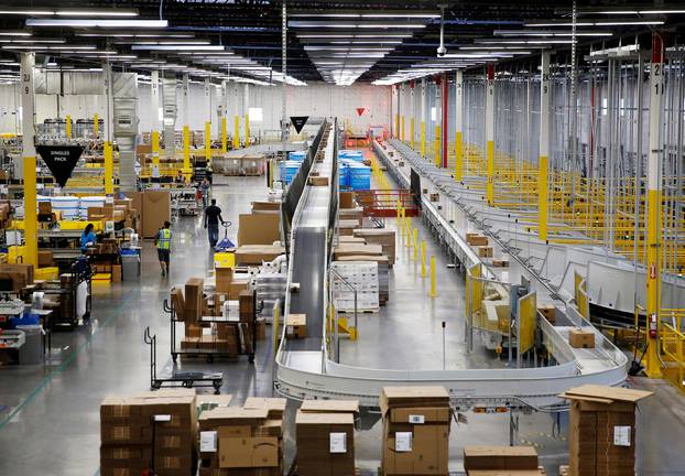 FILE PHOTO: The ship sorter automatically feeds packages for delivery by speed and location to chutes connected to delivery trucks at the Amazon fulfillment center in Kent