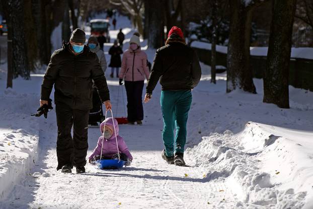 People play in the snow that fell during a Nor