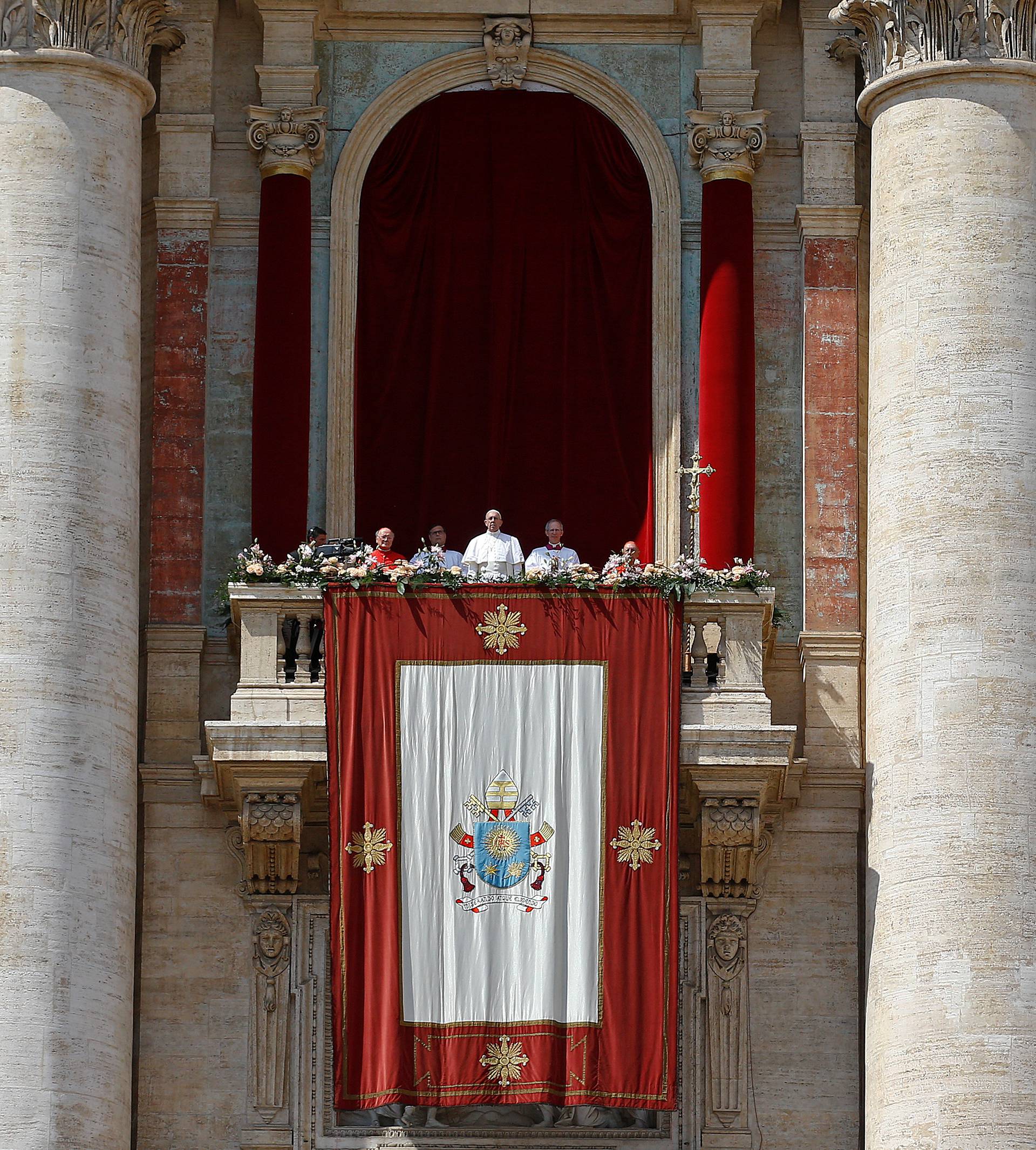 Pope Francis looks on before delivering his "Urbi et Orbi" (to the city and the world) message from the balcony overlooking St. Peter's Square at the Vatican