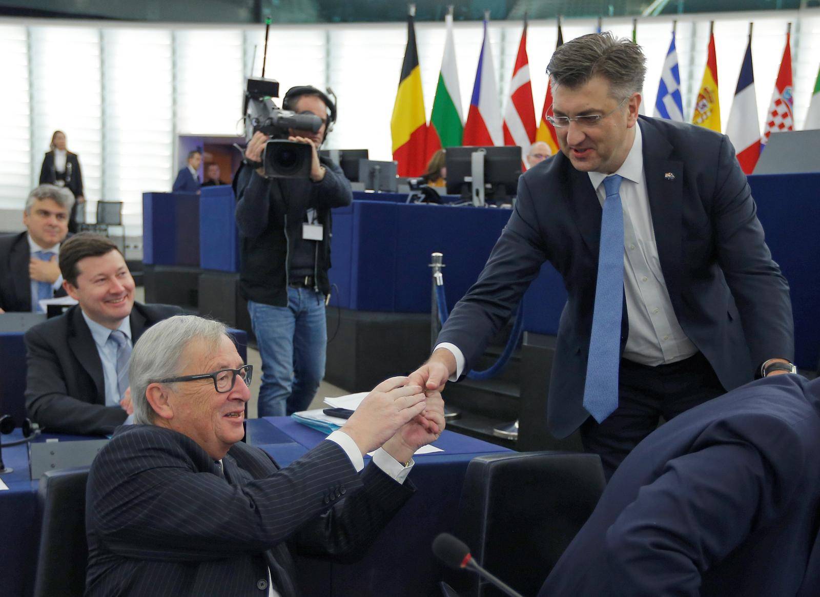 Croatia's Prime Minister Plenkovic shakes hands with European Commission President Juncker as he arrives to deliver a speech during a debate on the Future of Europe at the European Parliament in Strasbourg