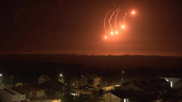 Flares descend on Gaza through the night