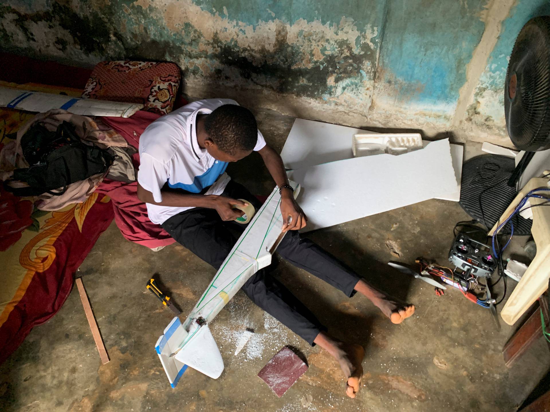 Bolaji Fatai builds a model aeroplane from discarded waste in Lagos