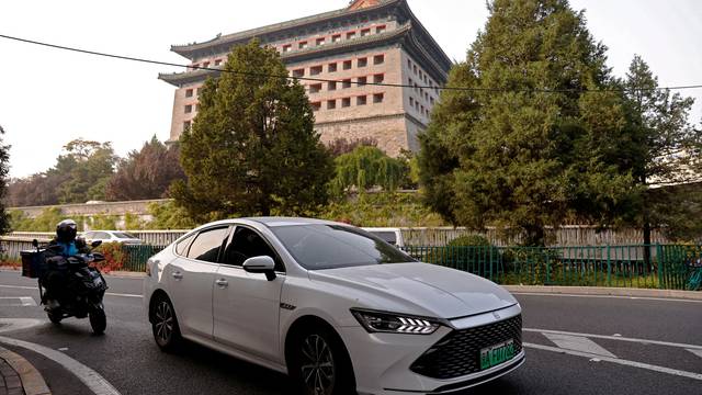 FILE PHOTO: FILE PHOTO: BYD's electric vehicle (EV) Qin moves on a street in Beijing