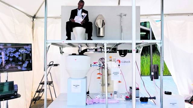 Doulaye Kone sits on the toilet at the winning prototype, a system designed by researchers from California Institute of Technology (exhibit 30) at the Reinvent the Toilet Fair in Seattle on August 12, 2012. Their model is a solar-powered toilet that gener