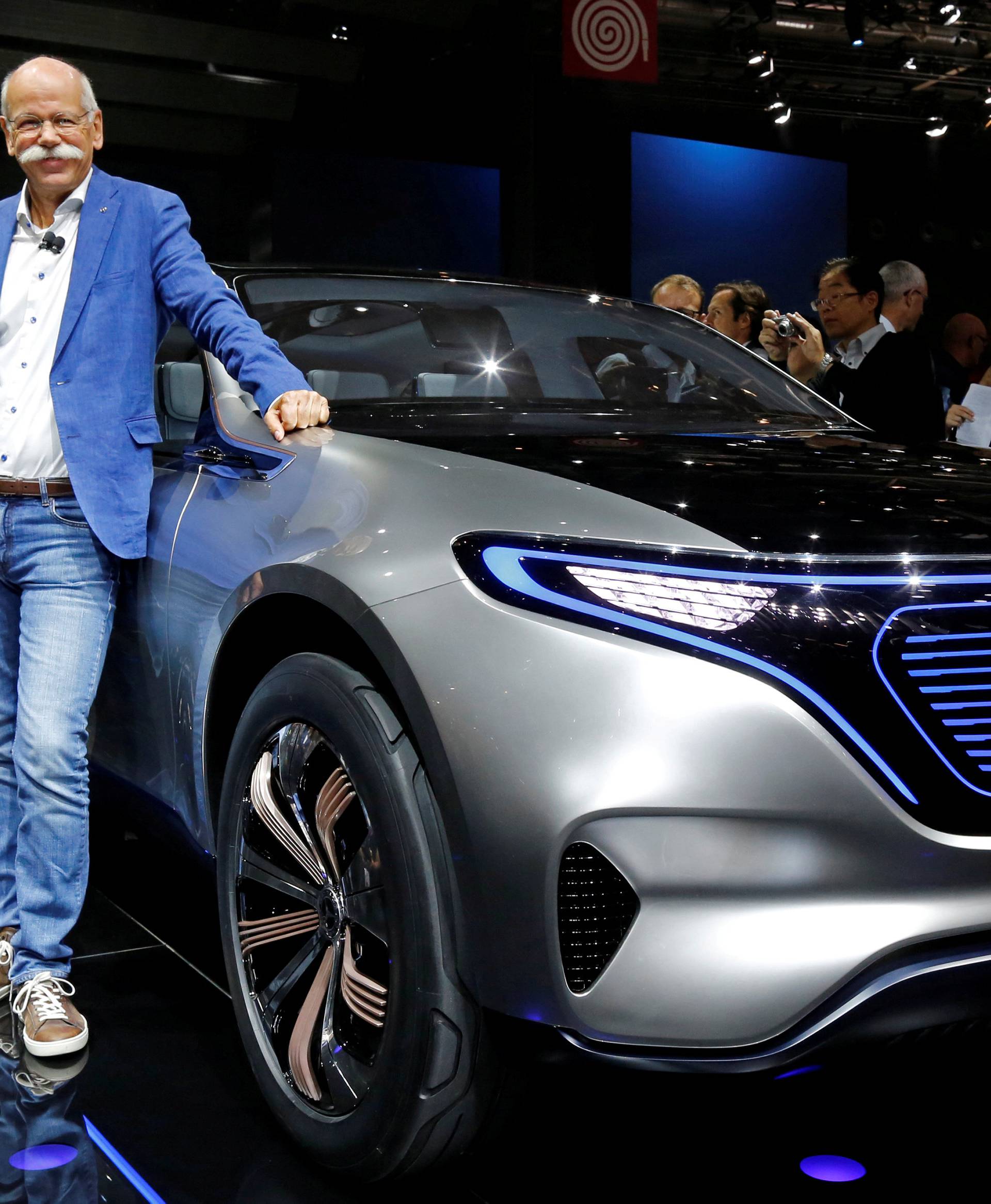 Dieter Zetsche, CEO of Daimler and Head of Mercedes-Benz, poses in front of a Mercedes EQ Electric car at the Paris auto show in Paris