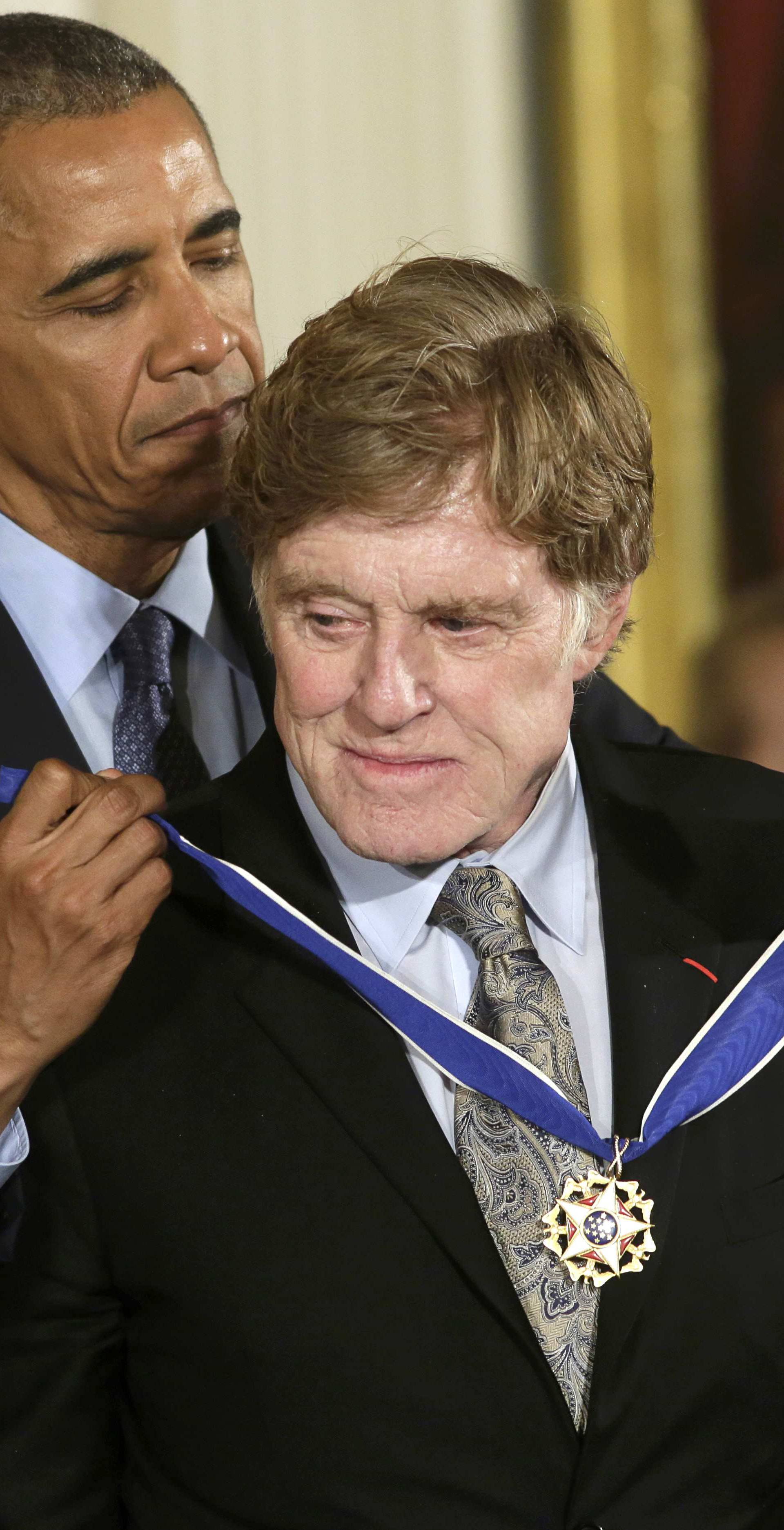 President Obama puts Presidential Medal of Freedom on actor Redford at White House in Washington