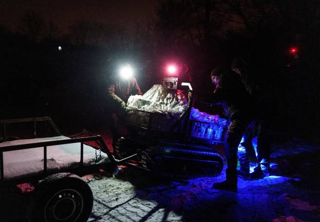 Ukrainian servicemen operate an unmanned ground vehicle fit for delivery missions on the frontline in Donetsk region