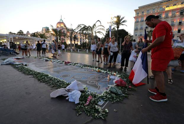 A man prays at a memorial on the Promenade des Anglais as part of the commemorations of last year