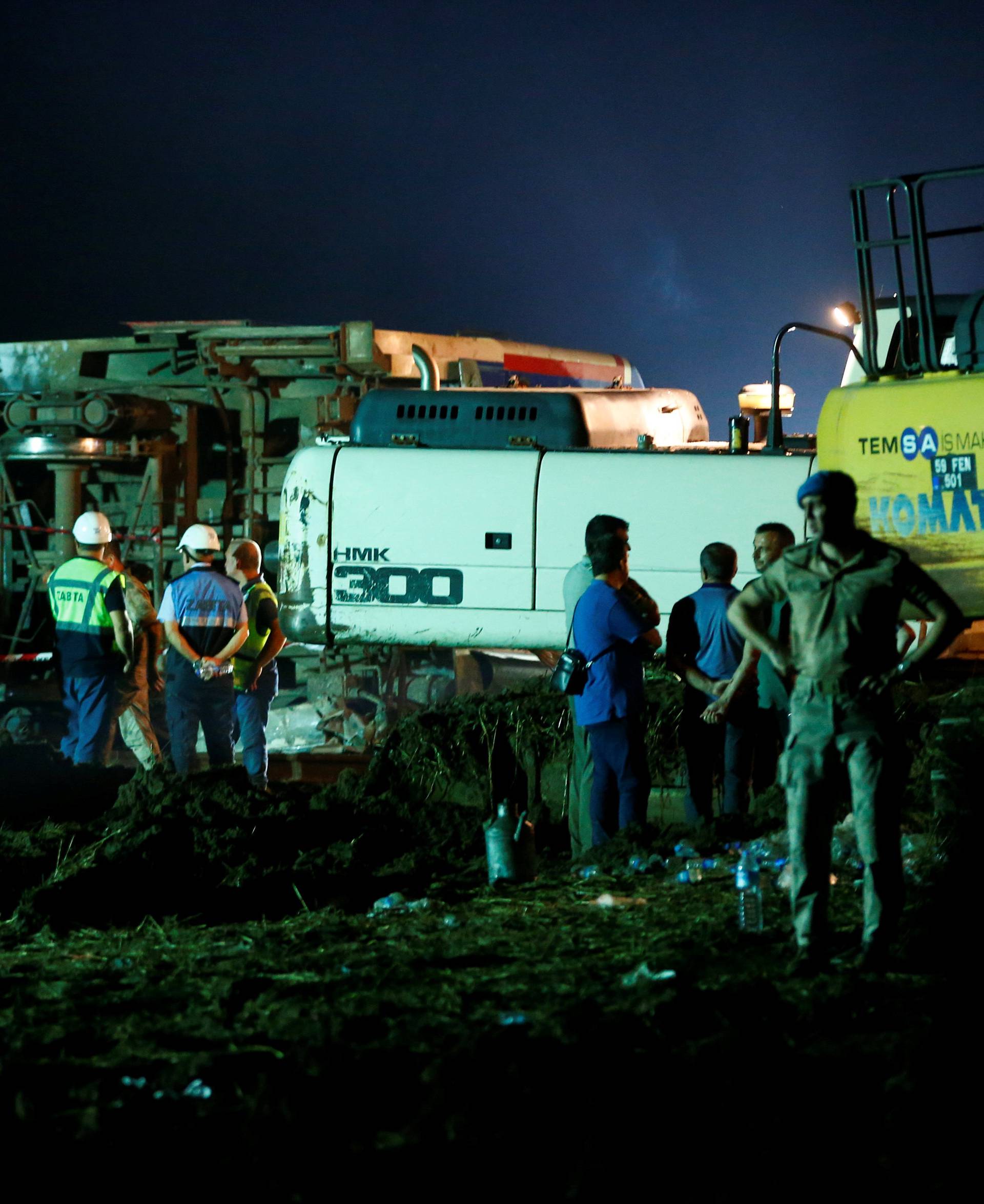 Rescue workers and paramedics work at the site of a train derailment near Corlu in Tekirdag province, Turkey