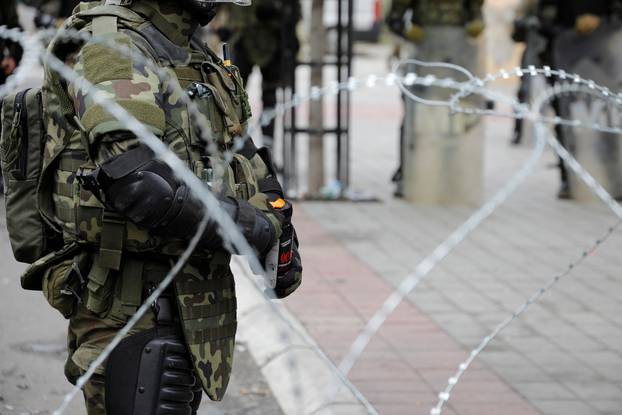 Polish members of the NATO-led Kosovo Force (KFOR) stand guard near a municipal office in Zvecan