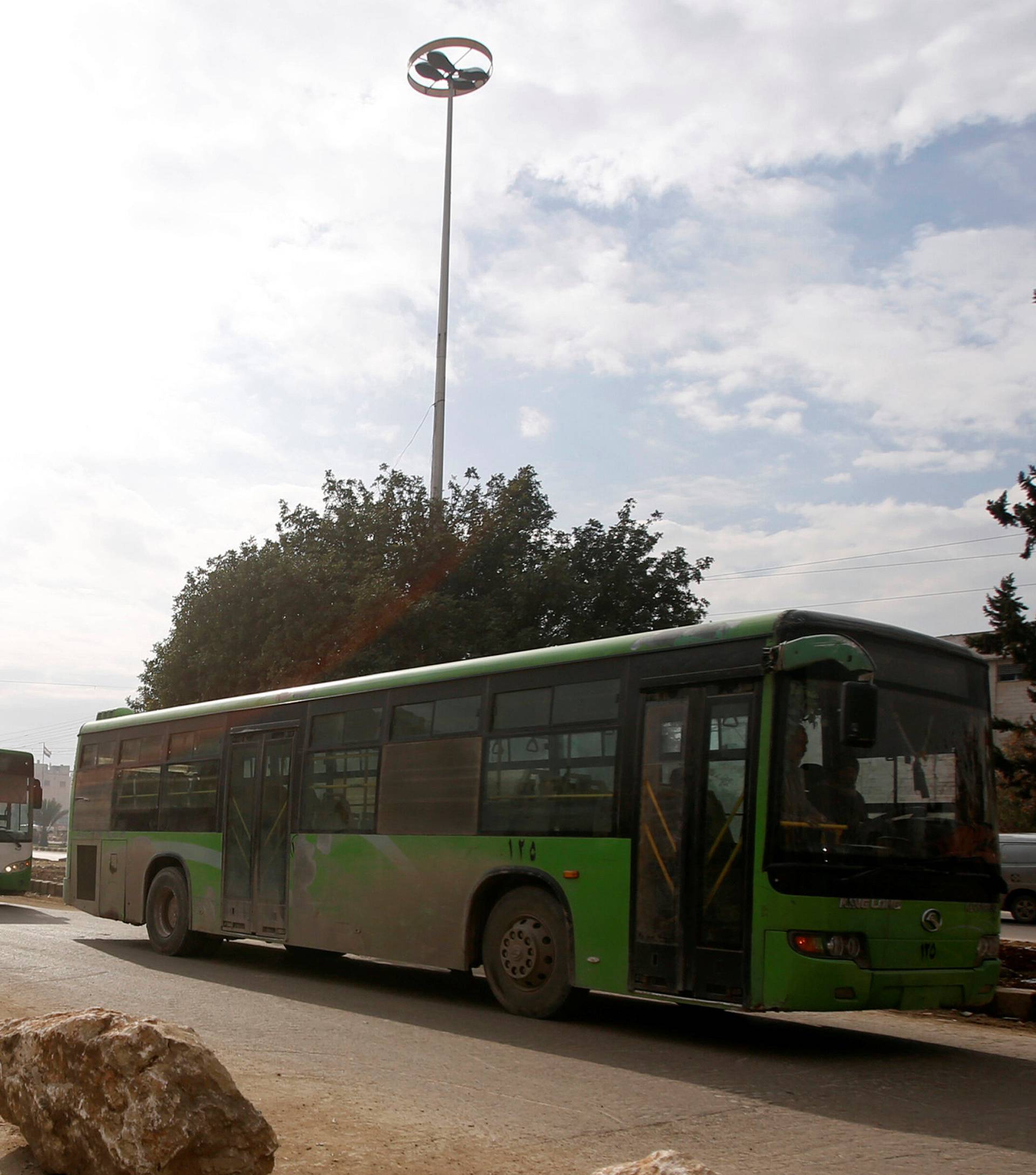 Empty buses are seen leaving after the evacuation of people from eastern Aleppo was suspended