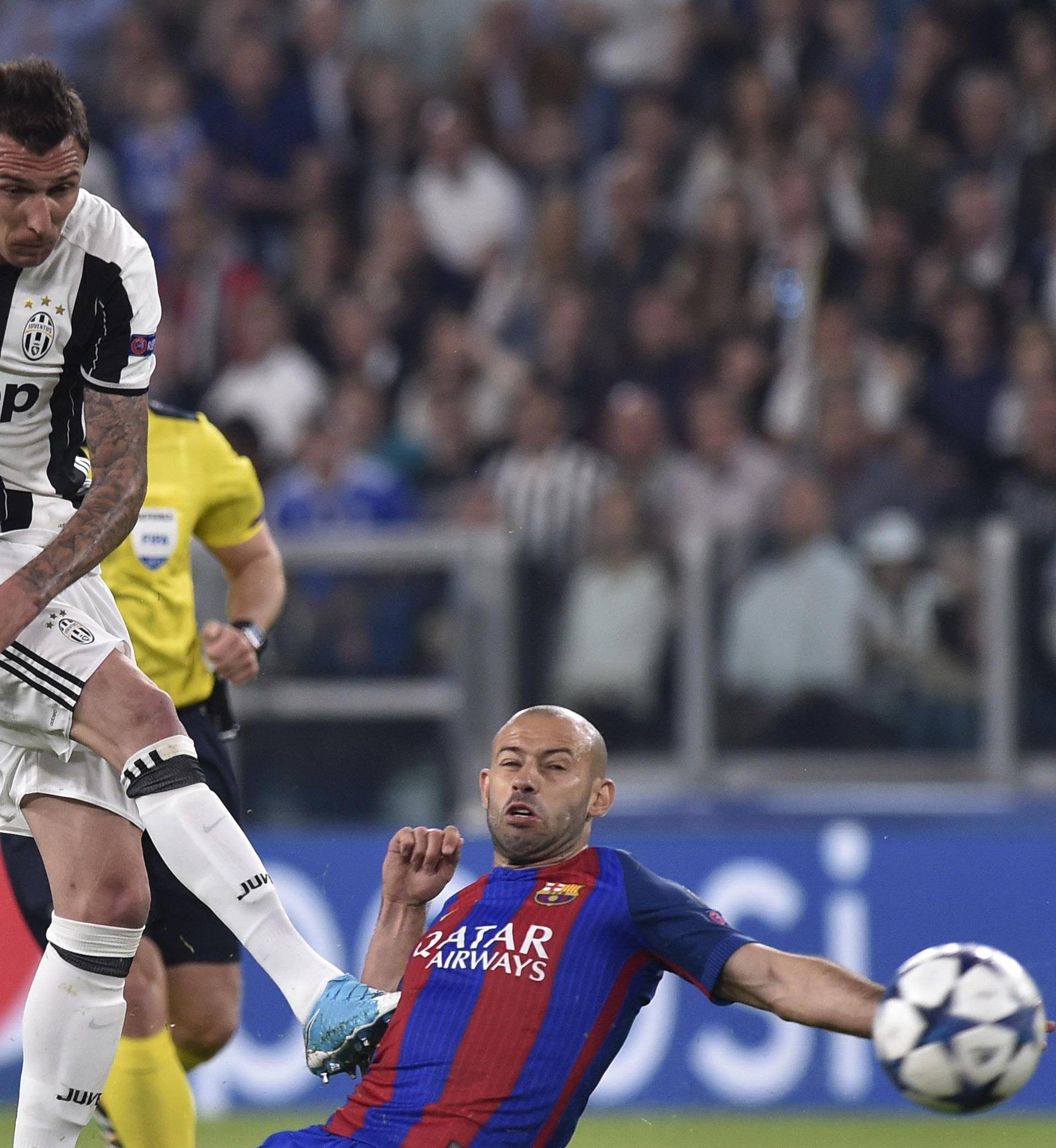 Barcelona's Javier Mascherano attempts to block a shot from Juventus' Mario Mandzukic