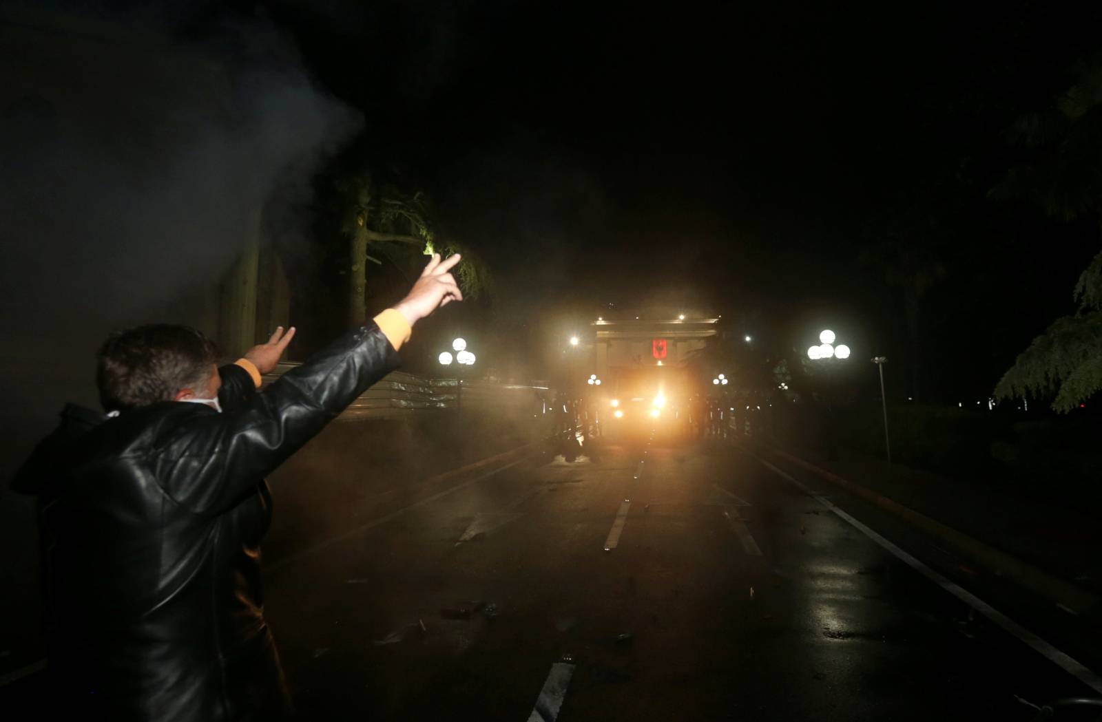 A supporter of the opposition party attends an anti-government protest in front of the Parliament Building in Tirana