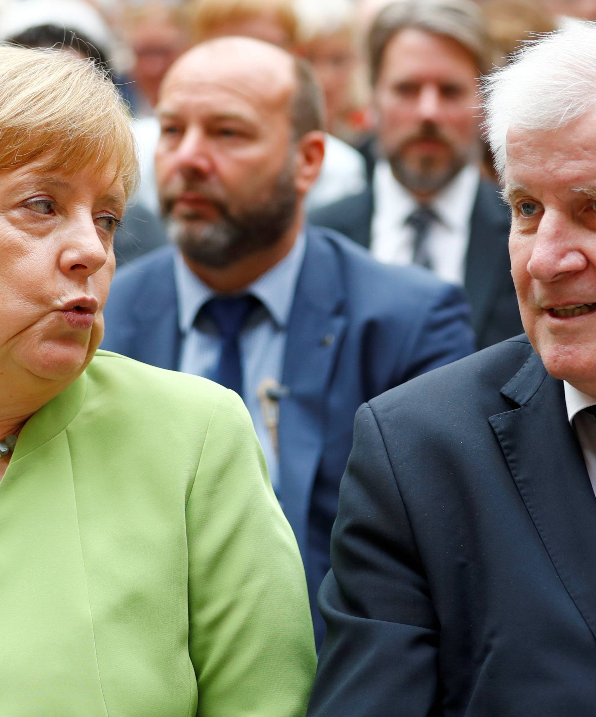 FILE PHOTO: German Chancellor Merkel and German Interior minister Seehofer attend an event to commemorate victims of displacement in Berlin