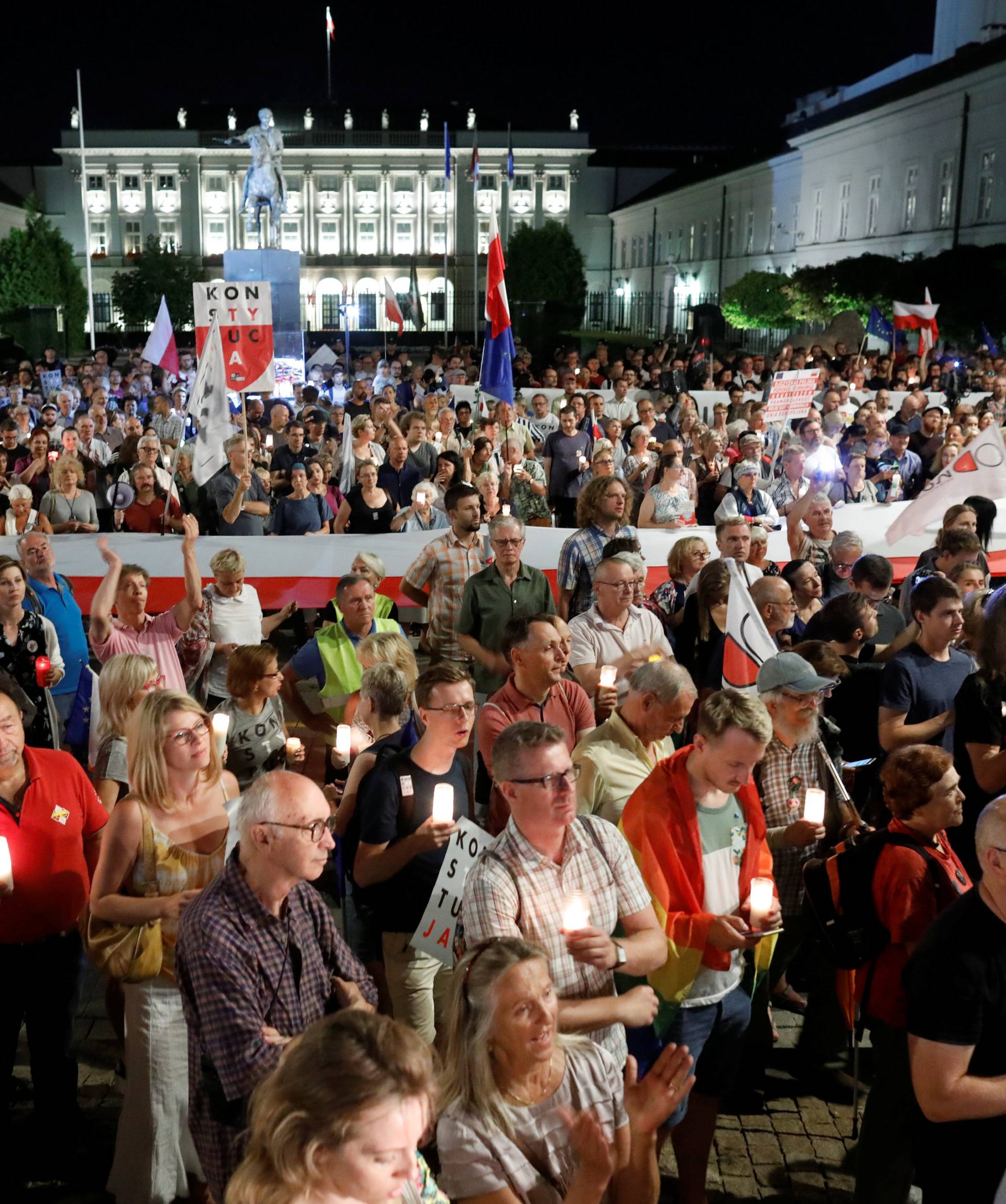 People gather during the "Chain of lights" protest against judicial overhaul in Warsaw