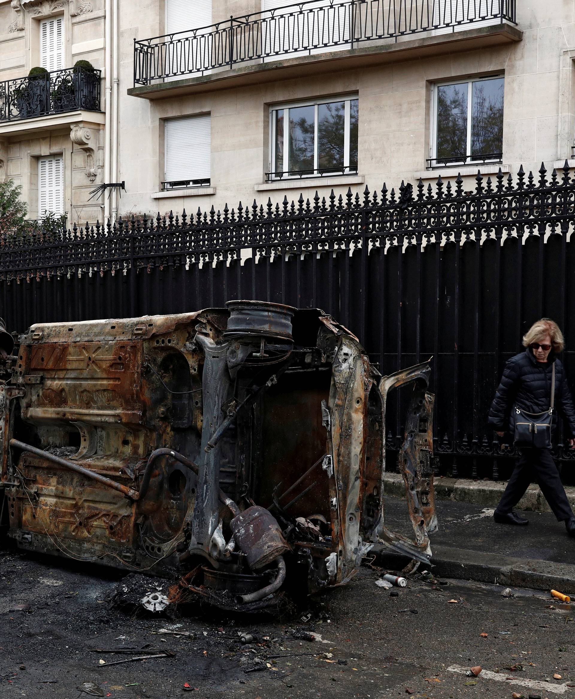 Vandalized cars are seen on a street the morning after clashes with protesters wearing yellow vests, a symbol of a French drivers' protest against higher diesel taxes, in Paris