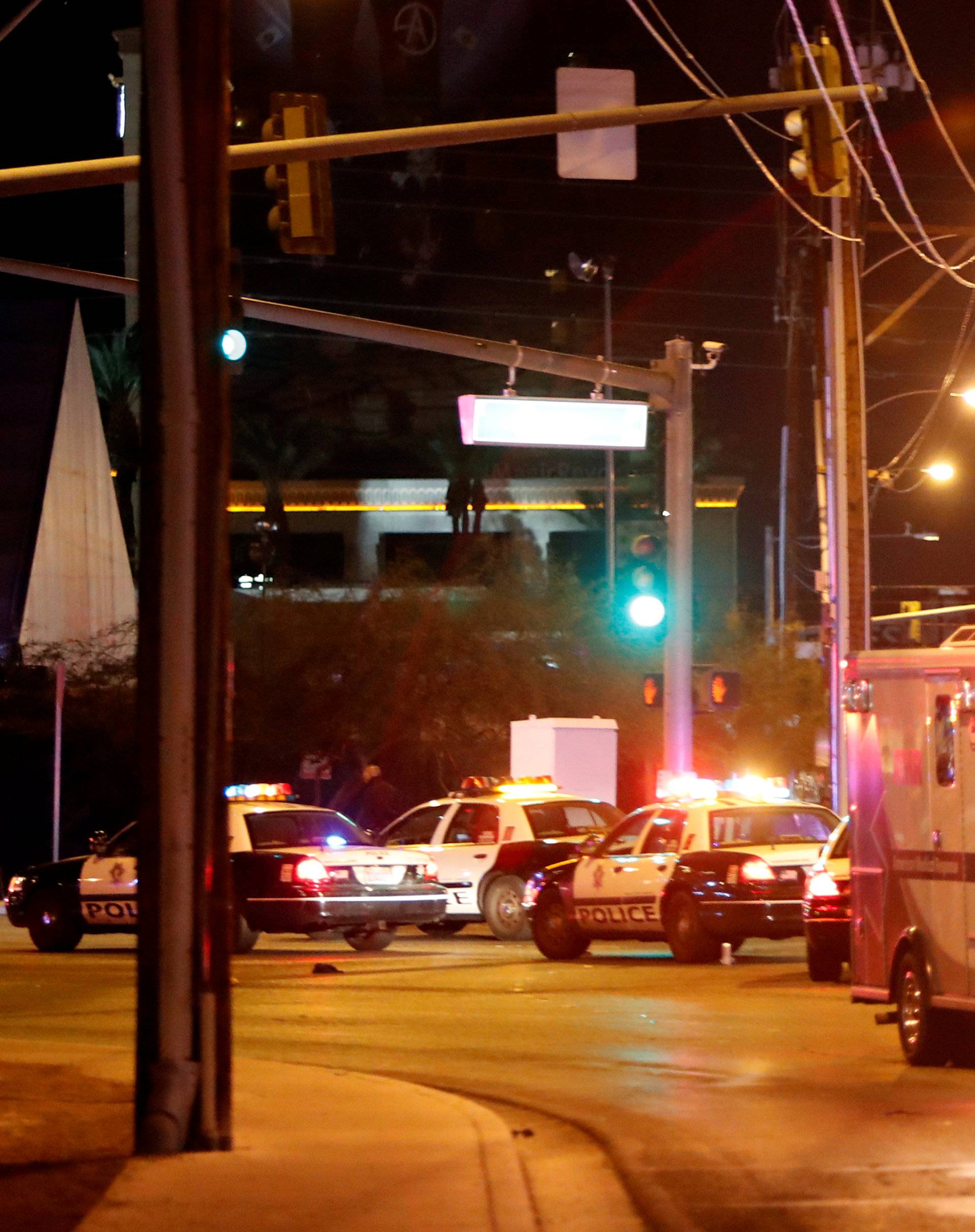 An ambulance leaves the concert venue after a mass shooting at a music festival on the Las Vegas Strip in Las Vegas