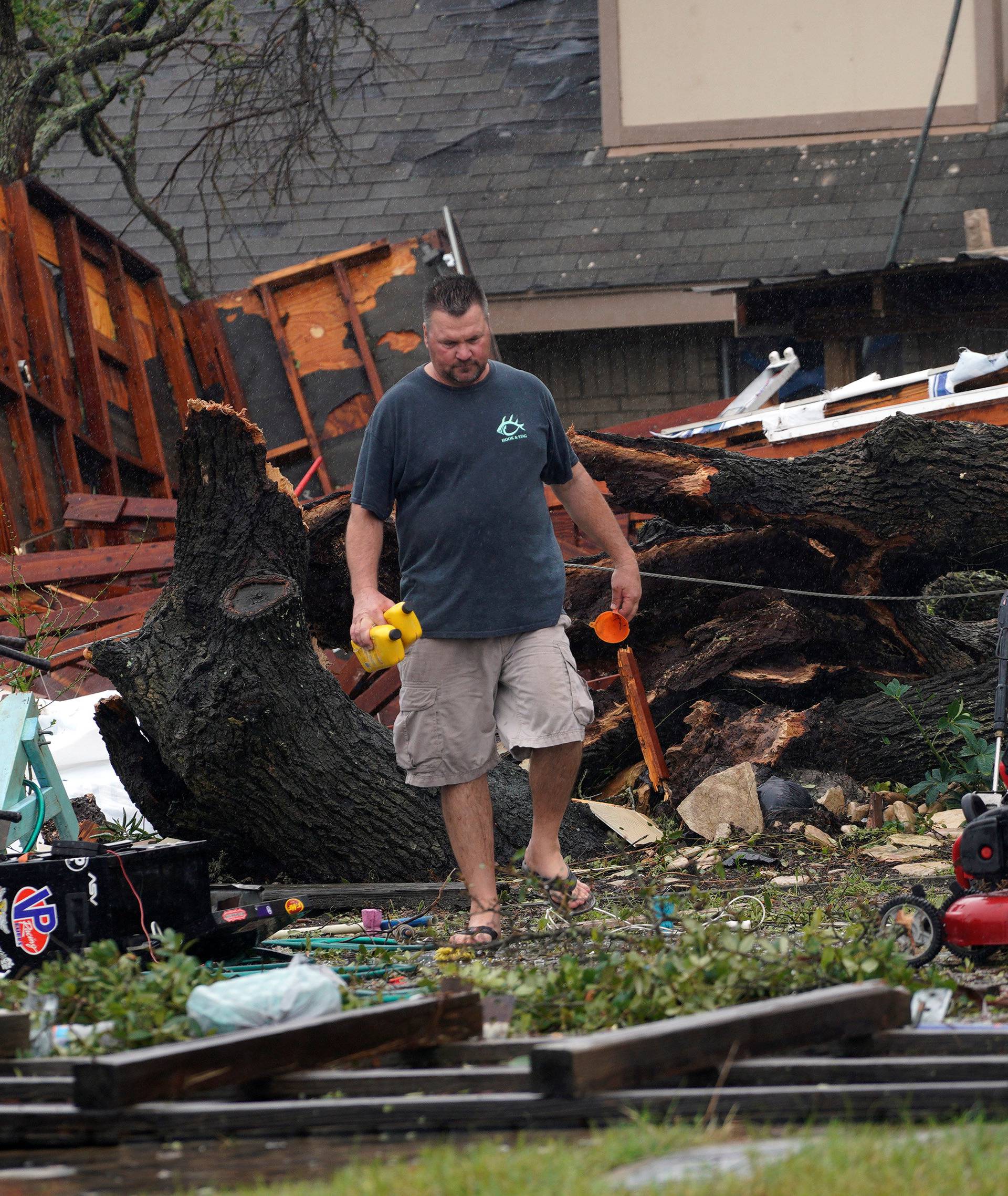 Tim Freiberg moves through what was his garage after Hurricane Harvey struck Rockport