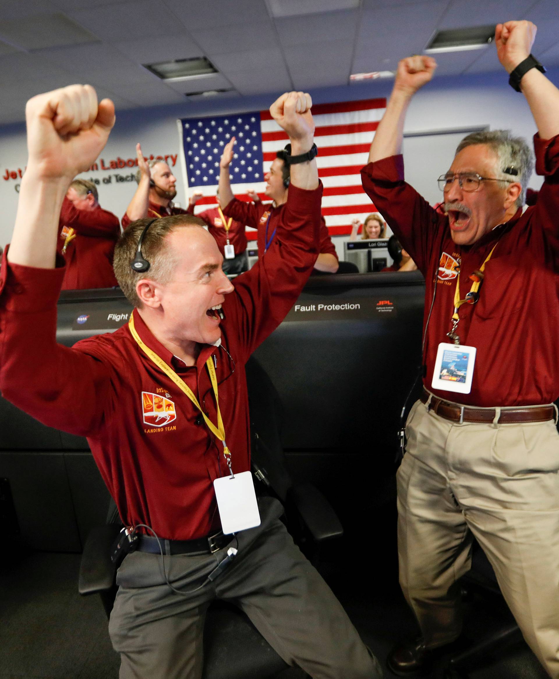 NASA engineers Kris Bruvold and Sandy Krasner react in the space flight operation facility at NASA's Jet Propulsion Laboratory (JPL) as the spaceship InSight lands on the surface of Mars after a six-month journey, at JPL in Pasadena