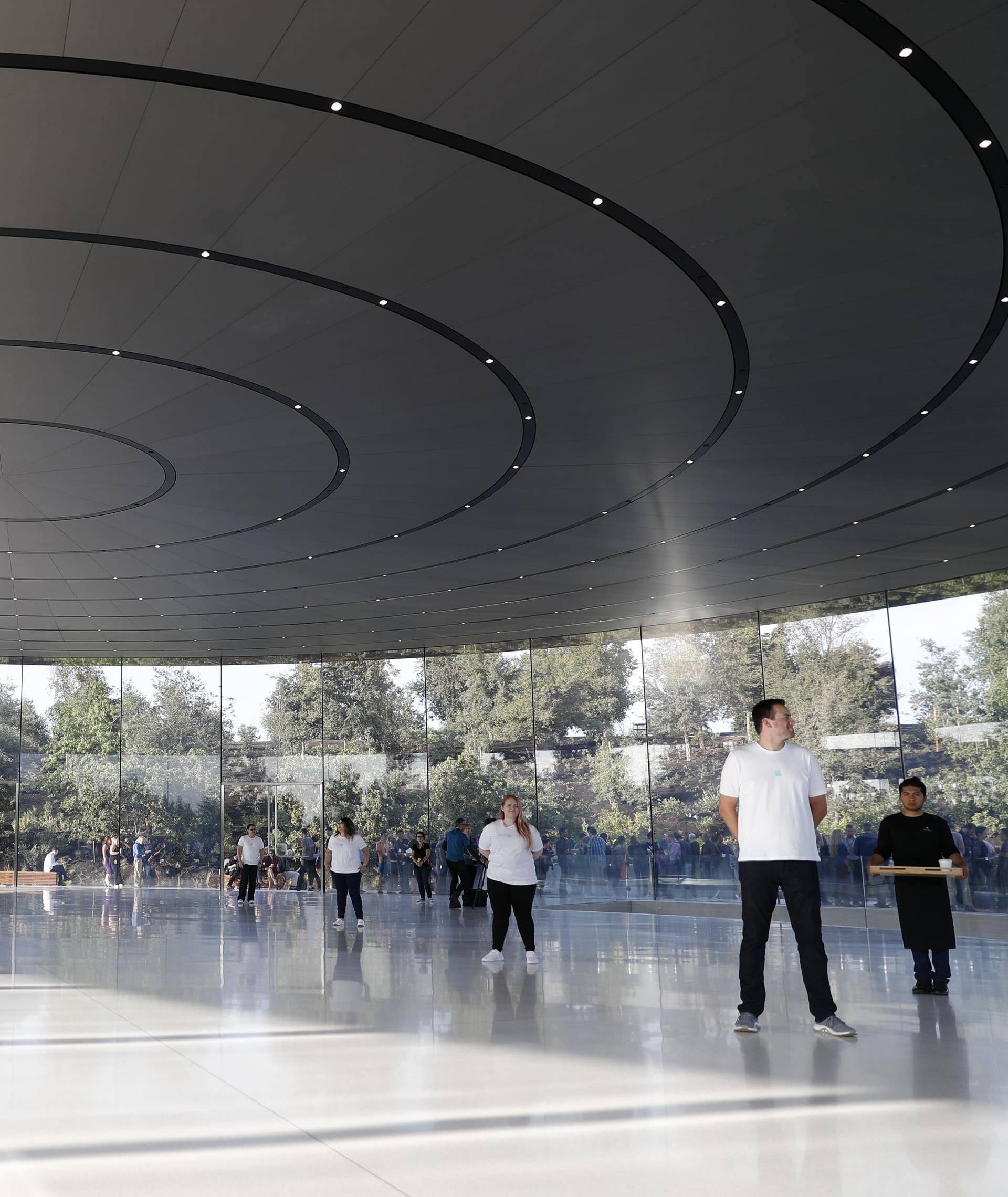 People await the start of a product launch event at Apple's new campus in Cupertino