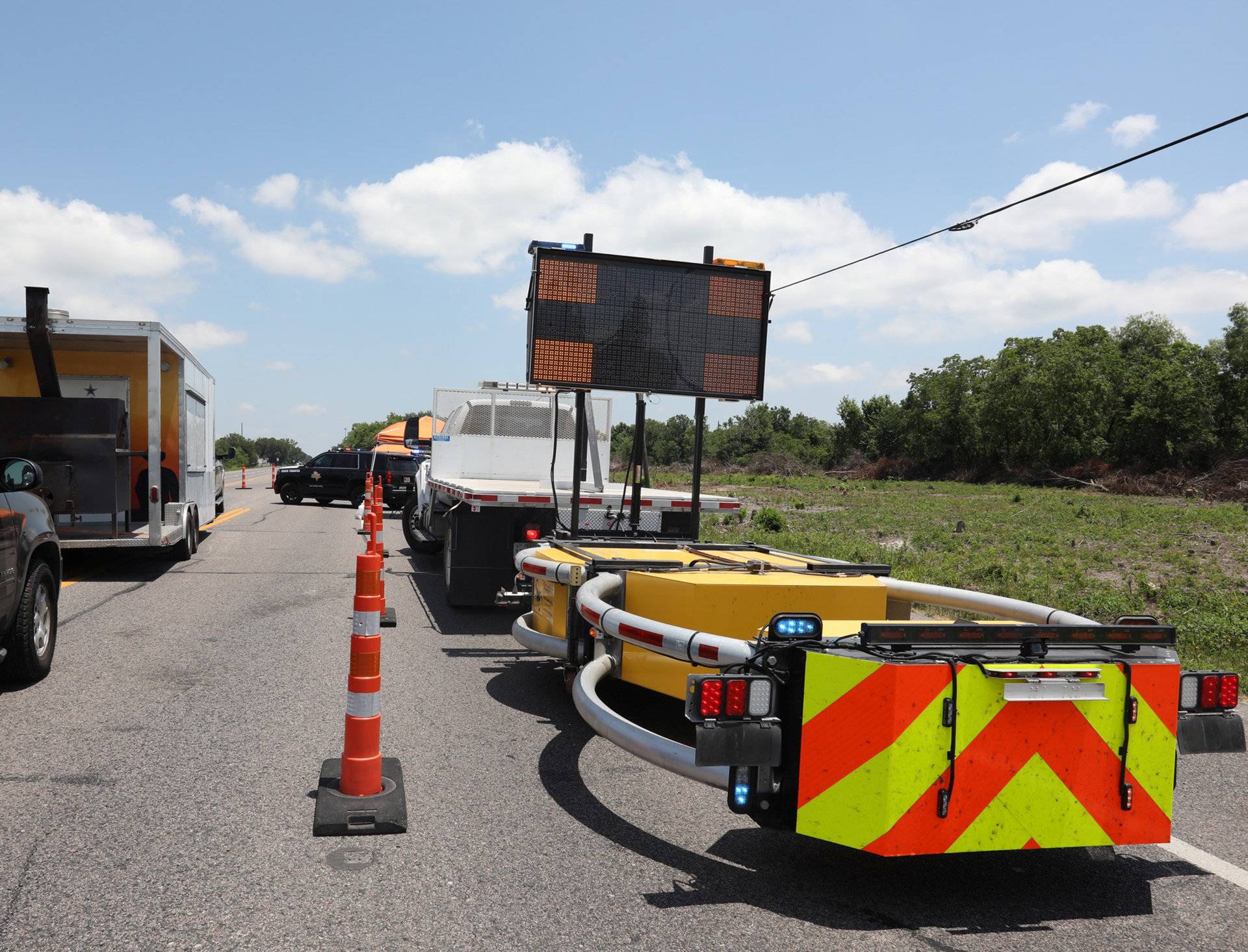 Police keep a roadblock on a main road to Santa Fe High School where police found explosives after an early morning shool shooting that left several people dead in Santa Fe Texas