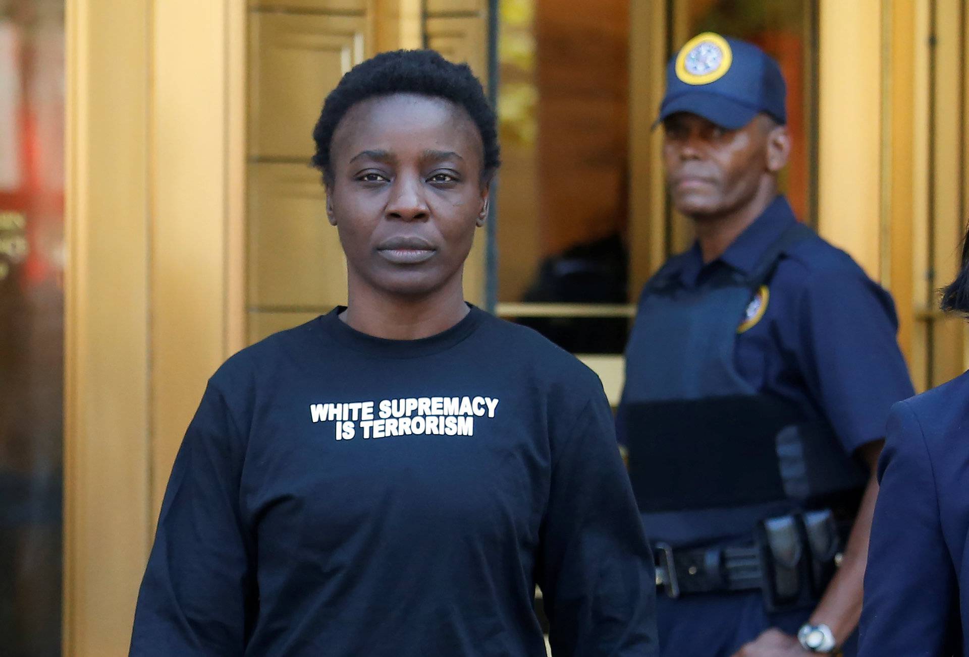 Patricia Okoumou walks out of federal court from her arraignment, a day after authorities say she scaled the stone pedestal of the Statue of Liberty to protest U.S. immigration policy, in Manhattan, New York