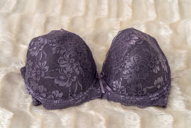 Seductive female bra on beige cloth