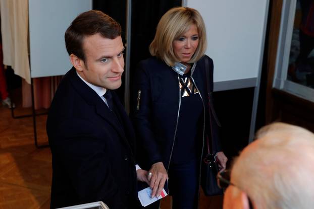French presidential election candidate Emmanuel Macron, head of the political movement En Marche !, or Onwards ! and his wife Brigitte Trogneux hold hands after voting in Le Touquet
