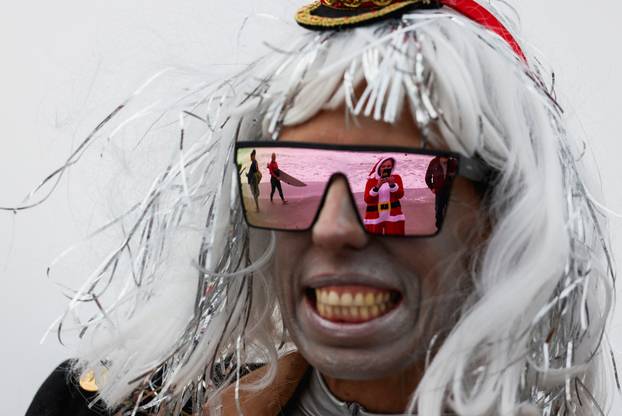 Surfing Santas take to the waves at the annual Christmas Eve event in Cocoa Beach