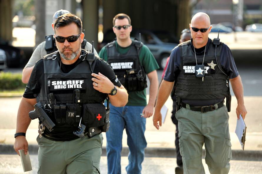 Officers arrive at the Orlando Police Headquarters during the investigation of a shooting at the Pulse nightclub, where people were killed by a gunman, in Orlando