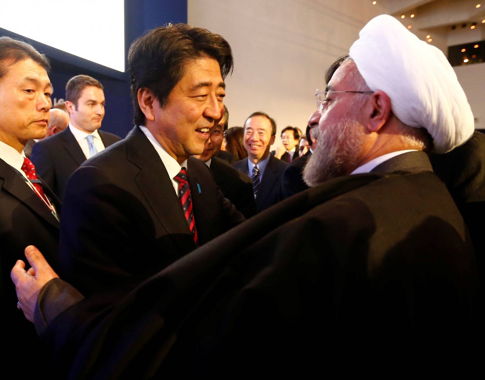 FILE PHOTO: Japan's Prime Minister Abe greets Iran's President Rouhani  at World Economic Forum in Davos