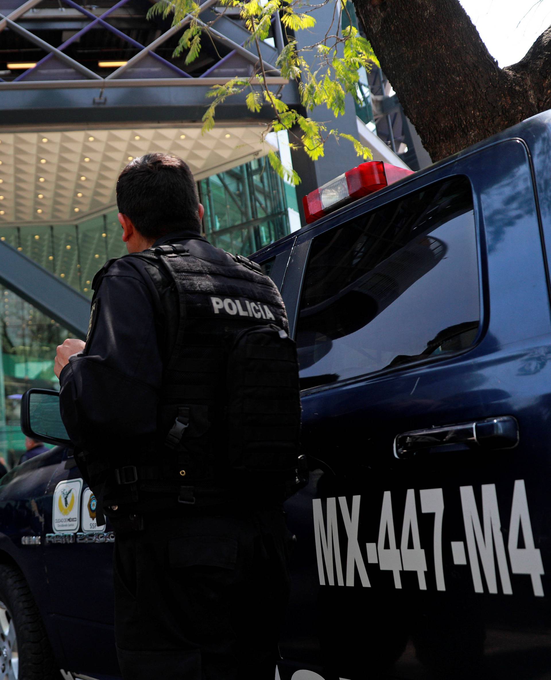 A police officer stands guard outside the tower after people were evacuated from the Mexican headquarters of Spain's BBVA, in Mexico City