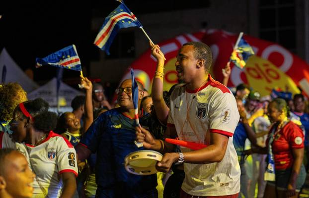 Fans of the Cape Verde national soccer team celebrate as they watch a World Cup group stage match against Uruguay in Praia