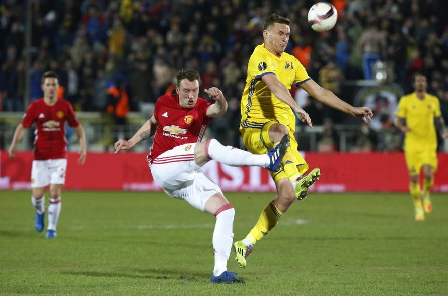 FC Rostov's Aleksandr Bukharov in action with Manchester United's Phil Jones